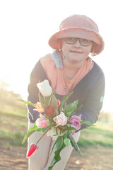 A bunch of tulips for you: young teenager girl wearing glasses and hat holding a bunch of tulips - 587053936