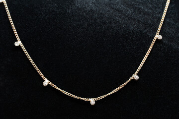Fototapeta na wymiar Gold chain jewelry with diamonds embedded in the chain macro photography