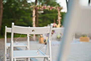 I took an emotional picture of the white chairs at the outdoor wedding ceremony