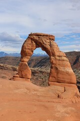 Fototapeta na wymiar Delicate Arch in Utah desert with Mountains behind
