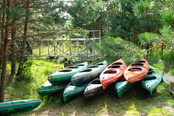 There are a lot of kayaks for a water hiking trip in a large group. Boat delivery and transportation, tourist service on a commercial trip