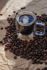 Coffee cup and coffee beans on a crumpled paper
