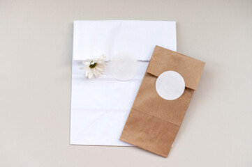 Round sticker mockup on gift white and kraft package, packaging with empty sticker, adhesive label