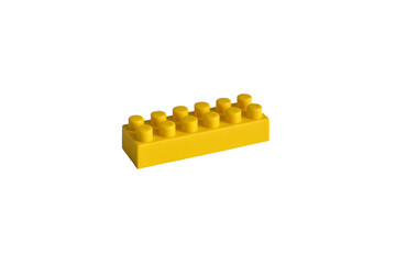 Yellow plastic part of a children's blocks constructor lies on a white background.