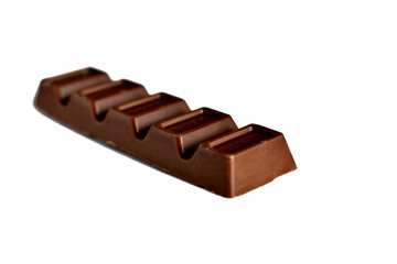 Narrow-shaped chocolate bar divided into pieces without a wrapper.