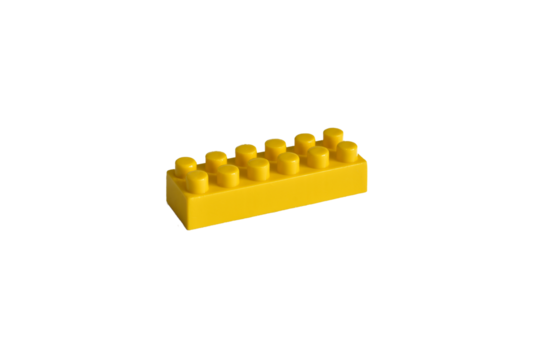 Yellow plastic part of a children's blocks constructor lies on a white background.