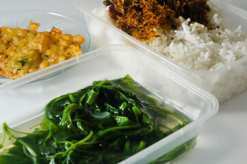 spinach vegetable menu, one of Indonesian specialties, consists of fried tempeh, white rice and fried chicken