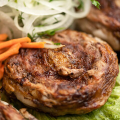Breaded meatloaf fried on grill with side dish of vegetables. Meat dish. Azerbaijani cuisine. Middle Eastern cuisine. Close-up. Soft focus. 