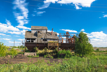 Fototapeta premium Old abandoned kolkhoz wooden grain elevator on the sunny summer day