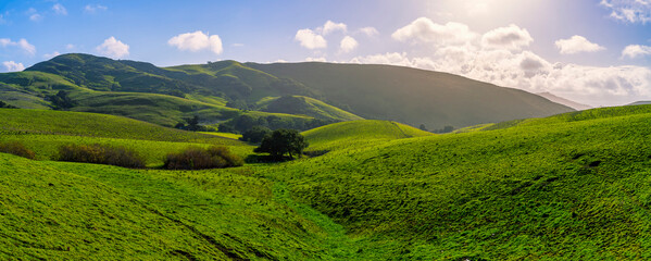Green landscape photograph of hills in Spring