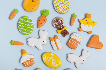 Easter gingerbread with icing on blue background. Top view