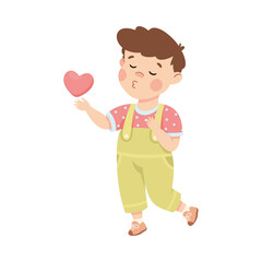 Cute loving little boy with pink heart. Brown haired boy dressed jumpsuit giving kiss cartoon vector illustration