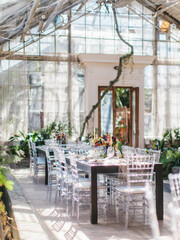 Decor for a fun banquet in a greenhouse. Glass stele, roslins hang down. Bottom line of the wedding.