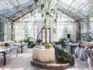 Decor for a fun banquet in a greenhouse. Glass stele, roslins hang down. Bottom line of the wedding.