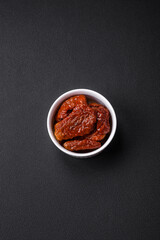 Delicious sun dried tomatoes in oil in a white ceramic bowl