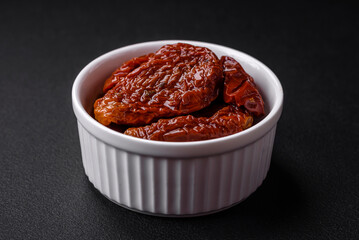 Delicious sun dried tomatoes in oil in a white ceramic bowl