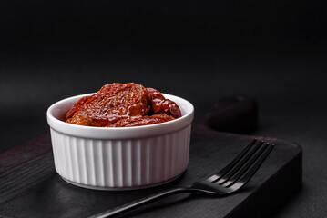 Delicious sun dried tomatoes in oil in a white ceramic bowl