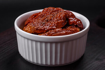 Delicious sun dried tomatoes in oil in a white ceramic bowl