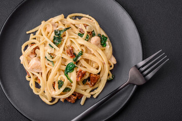 Delicious pasta with spinach, sun dried tomatoes, cheese, onions