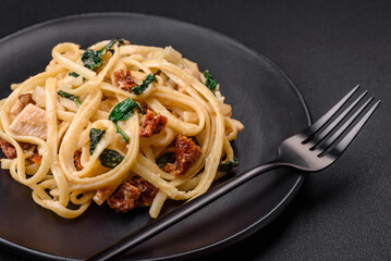 Delicious pasta with spinach, sun dried tomatoes, cheese, onions