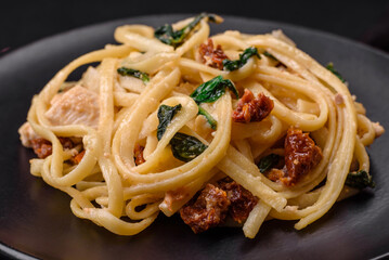 Delicious pasta with spinach, sun dried tomatoes, cheese, onions