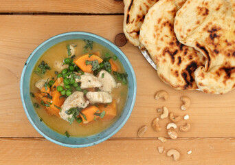 Coconut chicken curry with sweet potatoes and naan bread