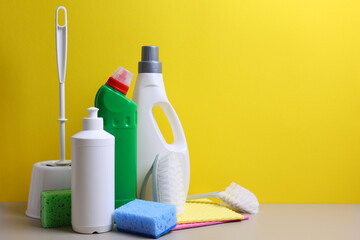 A set of different cleaning and disinfectant products on a coloured background