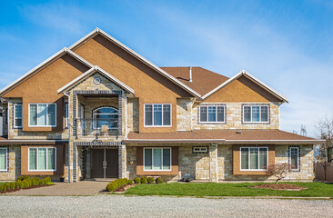 Real Estate Exterior Front House on a sunny day Big custom made luxury house with nicely landscaped front yard