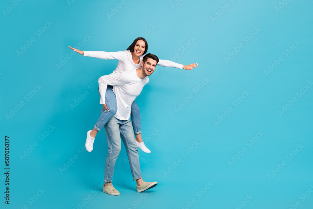 Aufkleber full size photo of two excited crazy partners hold piggyback arms wings empty space isolated on blue