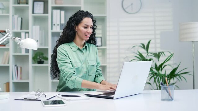 Thinking happy businesswoman working a new startup business project Writes an article. Gets envisions a groundbreaking idea sitting in office at workplace decides to pursue her dream and determination