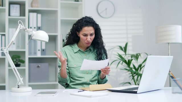 woman open letter envelope with bad awful news Receive notification with negative result sitting in office workplace Financial problem bank debt bill for pay tax invoice or bankruptcy dismissal notice