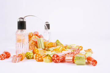 Colorful sweets and cologne, spilled group of colorful sweets and cologne. Bowl of candies, many...