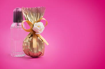 Luxury packaged chocolate, close up image of luxury packaged chocolate. Little cologne bottle and beautiful candy. Isolated pink background, copy space. Turkish sugar feast concept idea.