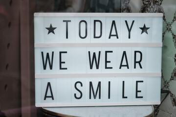 today we wear a smile signpost text