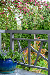 Fototapeta na wymiar terrace area with a gray railing and a blue flower pot.