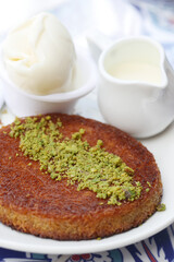 kunafa with a wipe cream on a plate .