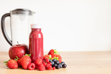 Healthy fresh red fruit smoothie with assorted ingredients of various berries. Superfood detox and diet concept. Top view, flat lay