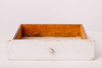 Closeup of a white vintage drawer on a white background