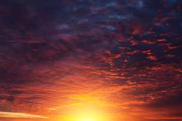 Epic dramatic sunset, sunrise on storm sky with dark clouds, orange yellow sun and sunlight