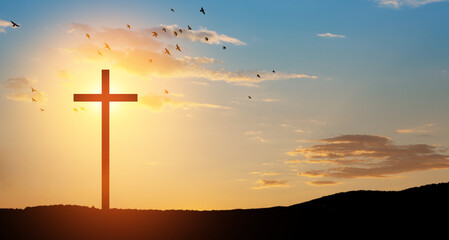 Naklejka premium Christian cross on hill outdoors at sunrise. Resurrection of Jesus.