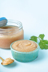 Bowl and jar with delicious caviar of capelin on blue background