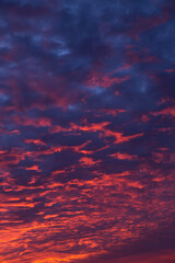 Epic dramatic sunset, sunrise on storm sky with dark and red clouds, in sunlight