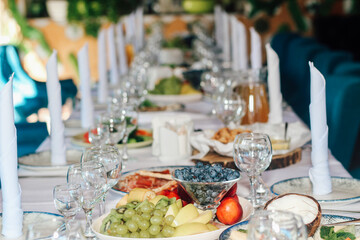 Banquet table served with dishes and snacks.