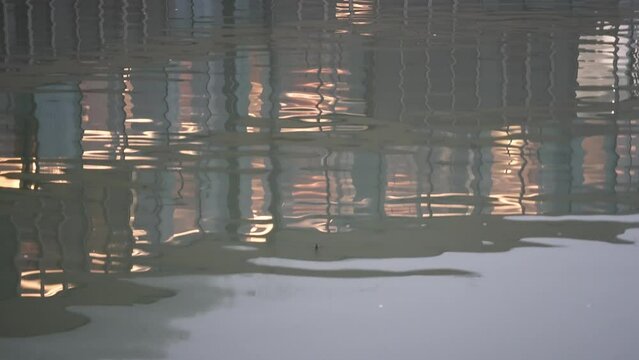 window of light and reflection on water