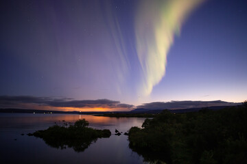 Naklejka na ściany i meble Aurora borealis over Thingvellir lake at dusk, Iceland