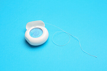 Case with dental floss on blue background