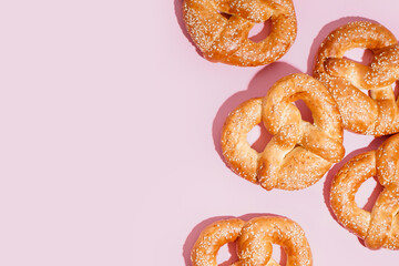 Tasty pretzels on pink background