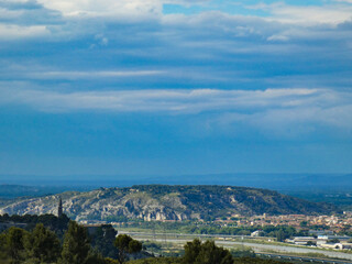 Magnificent landscape from the heights of the Alpilles in Provence in France on the iconic Saint-Jacques hill and part of the town of Cavaillon on the right