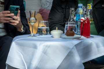 A man and woman sit at a table with white tablecloth - About December 2022, Bar, Montenegro 