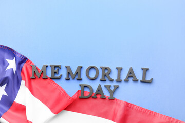 Fototapeta na wymiar Text MEMORIAL DAY with USA flag on blue background